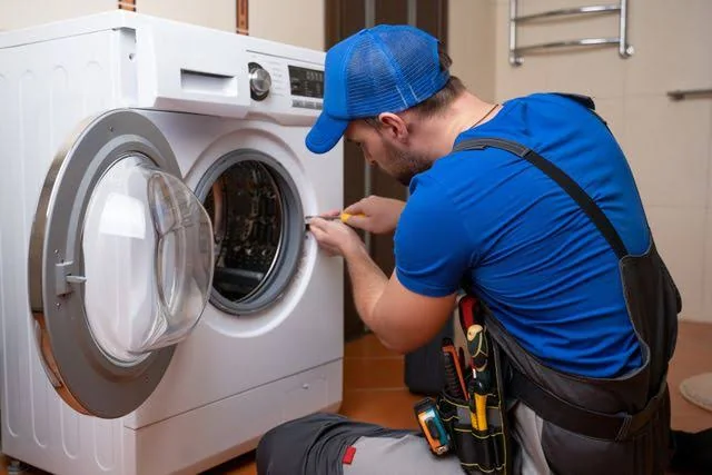 Independent appliance service professional working on a residential laundry appliance