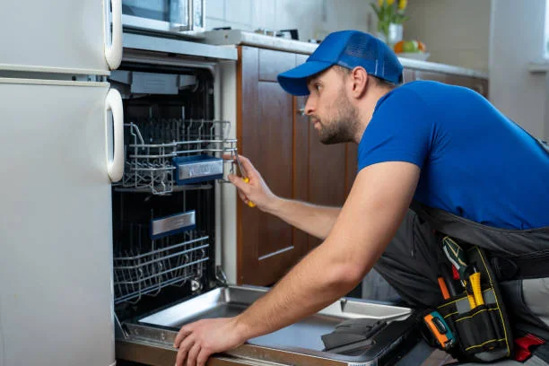 Independent appliance service professional examining an open residential dishwasher